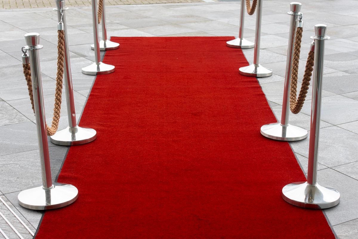 Rope stanchions defining an outdoor red-carpet entrance