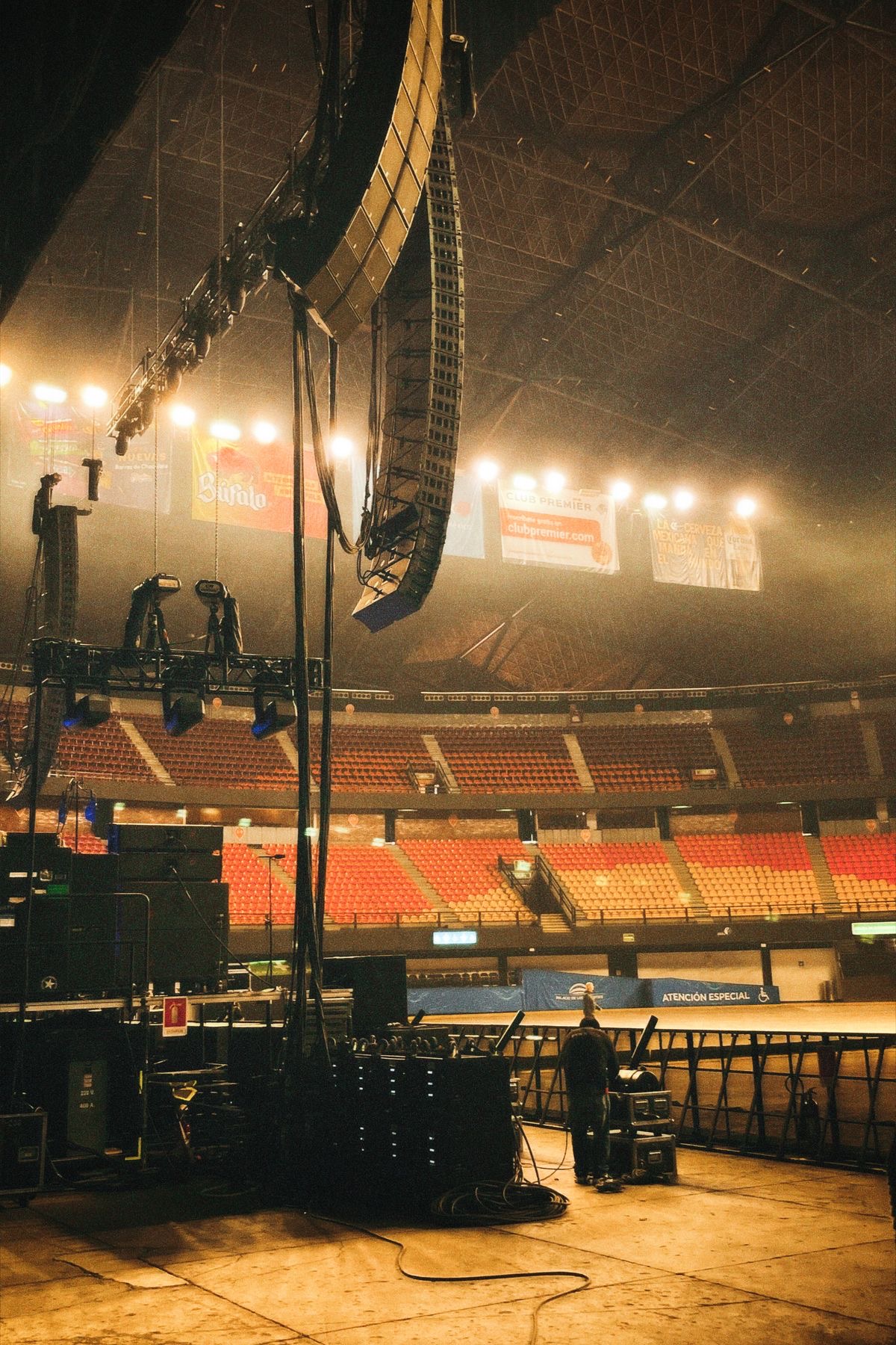Large indoor concert stage and production rig inside an arena